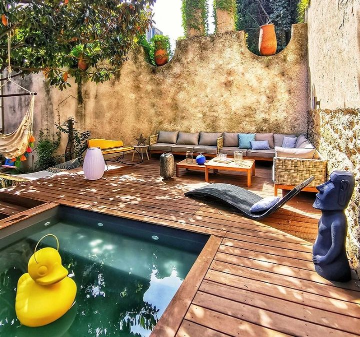 A Raised Lounge Area With A Small Pool Was Designed For This Backyard